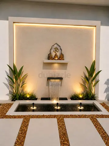 Modern outdoor water feature with integrated wall niche and lighting