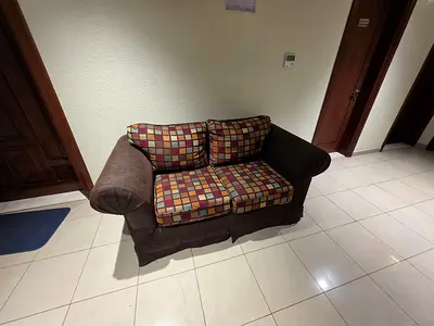 2-seater fabric sofa with patterned cushions - good condition
