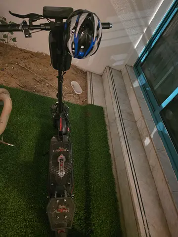 Used electric scooter with helmet - same as new .
