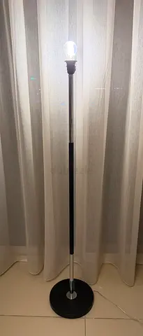 Simple chrome and black floor lamp with round base
