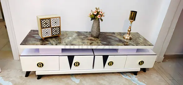 Modern white TV cabinet with marble-effect top