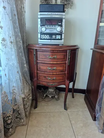 Antique-style wooden bedside cabinet with three drawers