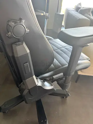 Black ergonomic gaming/office chair with adjustable armrests