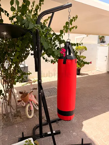 Red heavy punching bag with stand - good condition