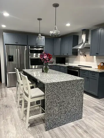 Modern kitchen with granite island and gray cabinetry - fully equipped