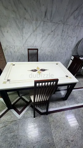 Dining table with chairs top of marble