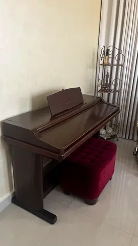 Yamaha digital upright piano in dark wood finish with matching bench