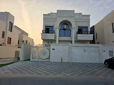 Villa for sale in Al Zahia, Ajman. 7 bedrooms, majlis, living room, spacious kitchen, and maid's room.