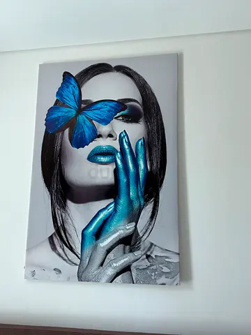 Framed Monochrome Portrait with Blue Butterfly and Metallic Accents (100 aed each)