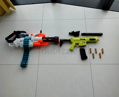A COMPLEX: Nerf Style Minigun, with a rifle that has a suppressor and a scope. DARTS ARE INCLUDED!!!