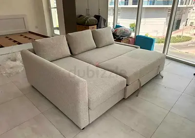 Light grey L-shaped sofa bed - converts to large double bed, good condition
