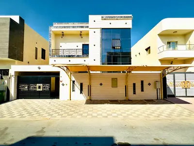 For sale in Al Yasmin, Ajman: a villa with 5 master bedrooms, a majlis, a living room, and a maid's room. Water, electricity, and air conditioning are