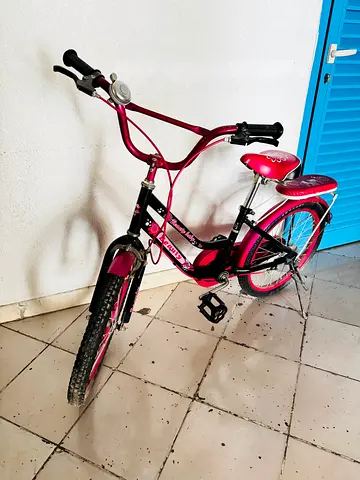 Pink kids bicycle with rear seat and bell - good condition
