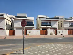 For sale in Al Helio 2, Ajman: a villa with 5 master bedrooms, 3 living rooms, and a spacious majlis