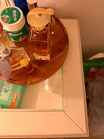 Small white wooden-top bedside cabinet with glass drawer