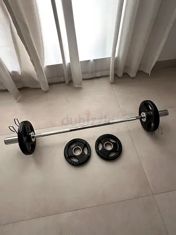 black weight plates and silver barbell