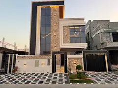 For sale in Al Yasmin, a two-story villa with a roof terrace, featuring 5 master bedrooms, a majlis,