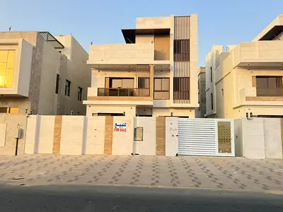 Villa for sale in Al Bahia, Ajman. 5 master bedrooms, large majlis, large living room, kitchen. 3 floors: ground, first, and roof.