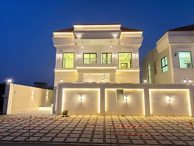 🏠 Villa for sale in Al Helio 2, Ajman: 4 master bedrooms, majlis, and 2 living rooms - central air conditioning - modern design with luxurious finish