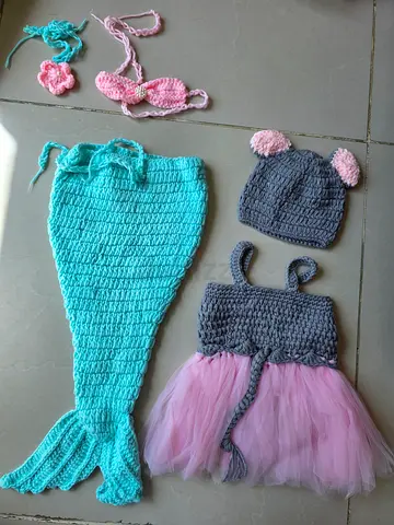 Newborn baby photoshoot items including mermaid, carrot, baby hand and feet molding frame