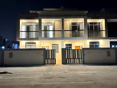 For sale in Al Bahia, a two-story townhouse with a roof terrace, featuring 6 master bedrooms, a living room, a majlis (formal sitting room), and a spa