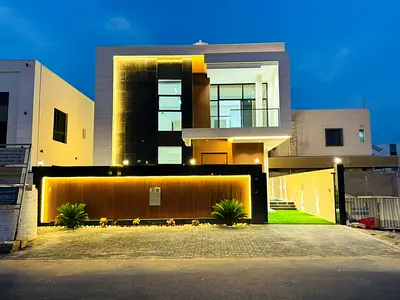 For sale in Al Bahia, a two-story villa with a rooftop terrace, a swimming pool, 4 master bedrooms, a majlis, 2 living rooms, and a maid's room.