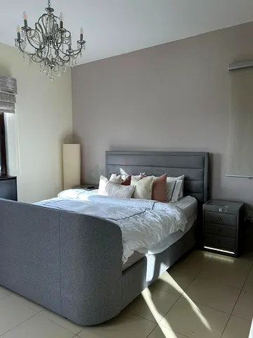 Grey upholstered king-size bed with storage and headboard