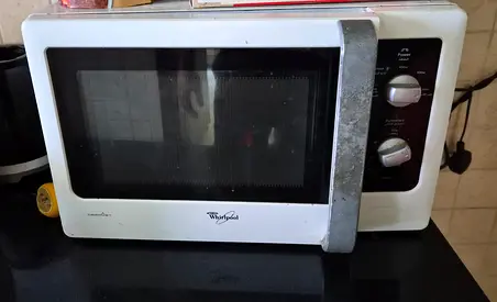 Working and in Good condition -Whirlpool Microwave Oven - Compact for daily use .