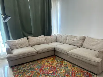 Beige L-shaped fabric sofa