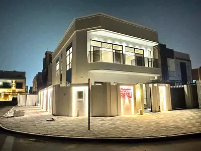 For sale in Al Bahia, Ajman: Corner villa with 5 master bedrooms, a majlis, a living room, a kitchen, and a maid's room.
