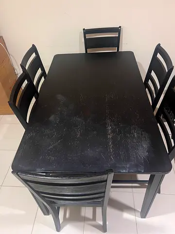 Used black wooden dining table with 6 chairs - sturdy set