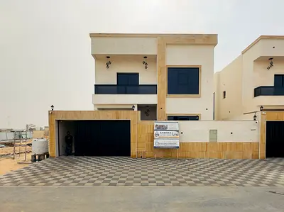 For sale a villa in Al Helio 2 in Ajman, 5 master bedrooms, a majlis, a hall, a maid's room, and a store