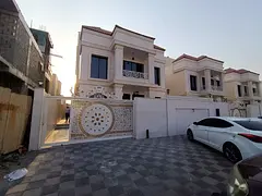 For sale, a villa in Al Helio 2, Ajman, consisting of 4 master bedrooms, a majlis, a hall, and a mai