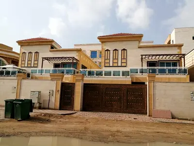 For sale in Al Muwaihat: 2 villas, 6 master bedrooms, majlis, living room, and maid's room