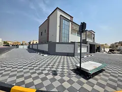 For sale, a villa in Al Rawda 2, Ajman, 5 bedrooms, a living room, two halls, a kitchen with a maid&