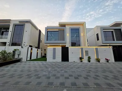 Villa for sale in Al Zahia, Ajman, consisting of 3 floors (first, ground and roof), 5 master bedrooms, living room, hall with kitchen and maid's room