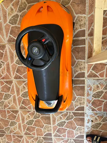 Orange ride-on push car for toddlers with steering wheel