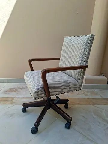 Mid-century style wooden office swivel chair with upholstery.