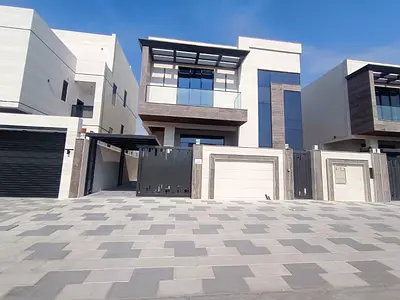 For sale in Al Bahia: a villa with 5 master bedrooms, a majlis (formal sitting room), two living rooms, two kitchens, built-in wardrobes, a balcony, a