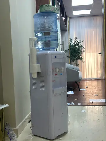 Used Office Water Cooler Dispenser with Bottle and Cup Holder