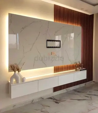 Modern wall-mounted TV entertainment panel with LED backlighting and floating cabinet