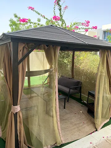 Outdoor metal gazebo with curtains and seating - usedb