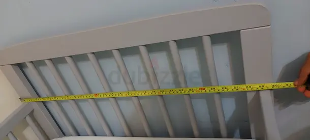 Used wooden baby crib (side rail) – sturdy, measured width shown