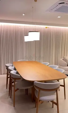 Modern Dining Table with Architectural Base and Smooth Circular Surface