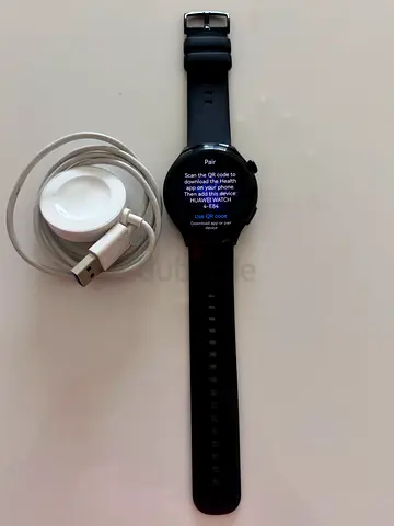 Used round Android-compatible smartwatch with magnetic charger - good condition