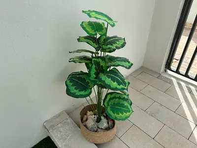 Artificial potted decorative plant with woven basket