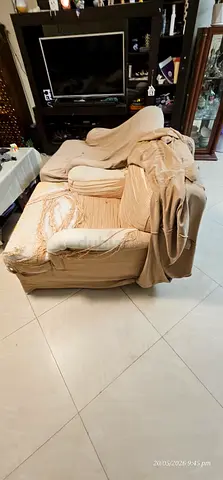 Used beige fabric armchair — needs reupholstery/repair