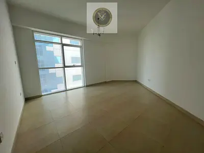 Two bedrooms and a living room with a balcony, storage room, laundry room, and parking