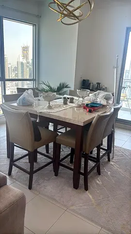 Solid wood dining table with 6 upholstered high chairs - good condition