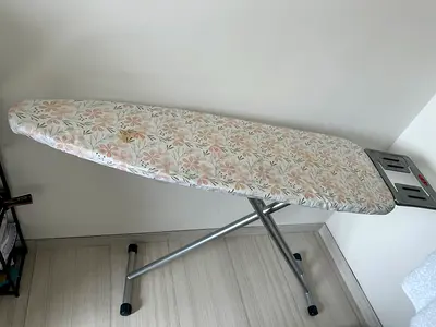 Sturdy adjustable ironing board with floral cover